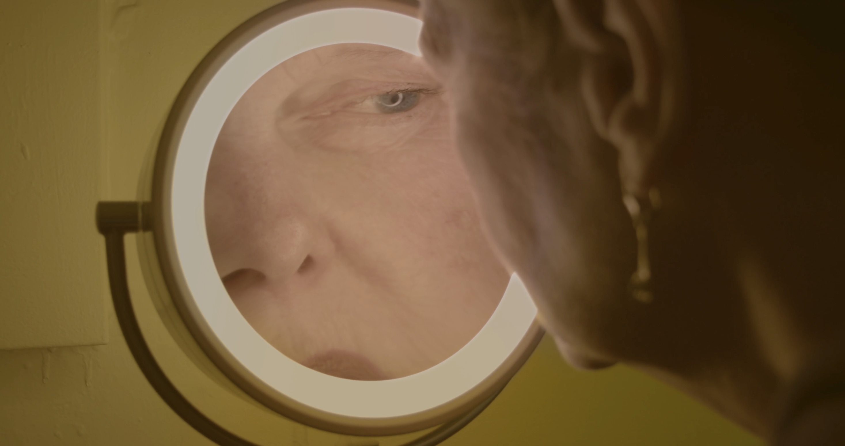 Nona Bucco 03 woman in yellow room mirror.