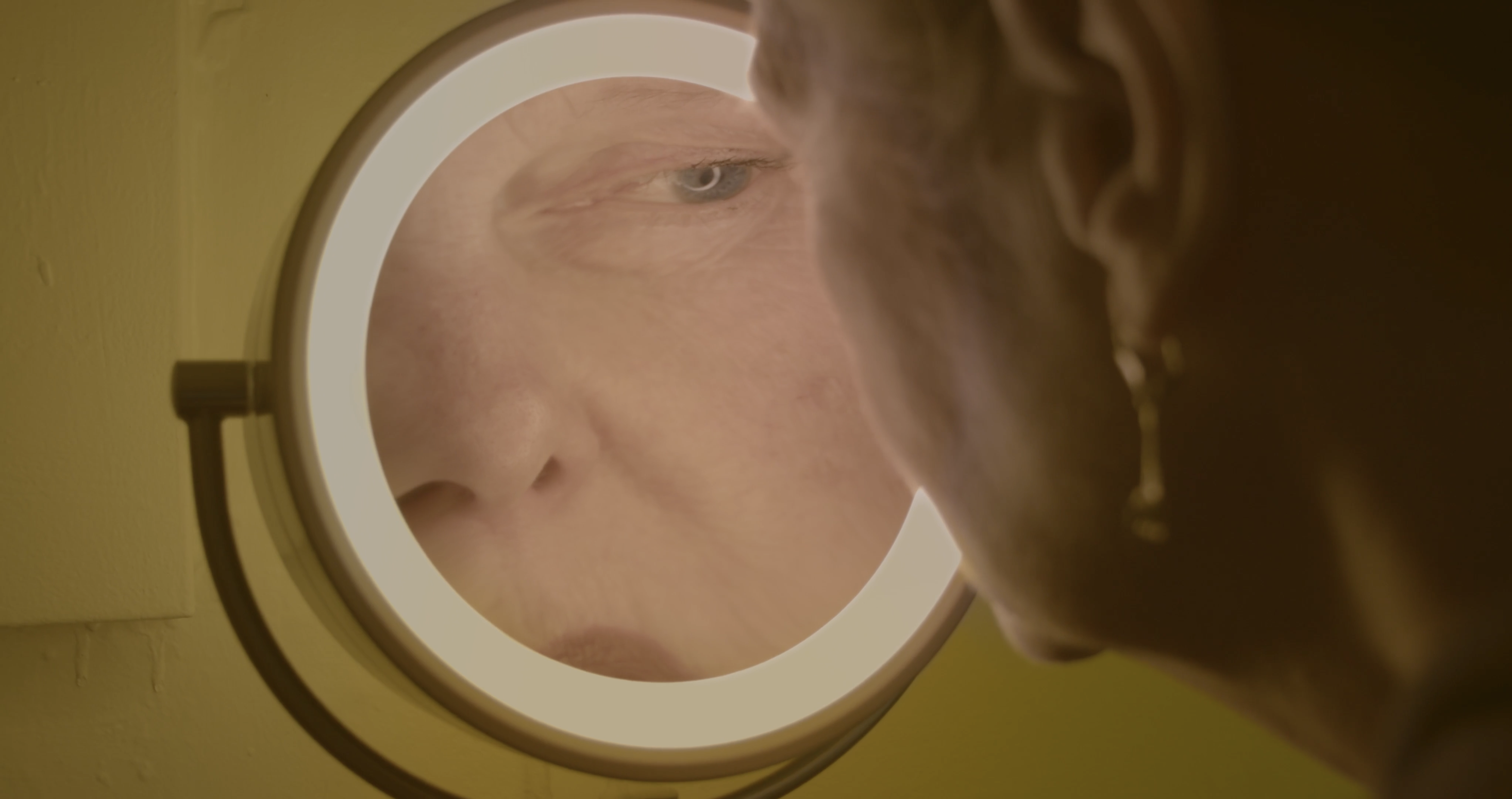 Nona Bucco 03 woman in yellow room mirror.